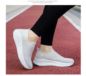 Side view of lightweight grey slip-on walking sneakers with breathable knit mesh texture