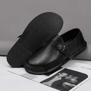 Detailed macro view of genuine black leather casual shoes with wide toe box and buckle