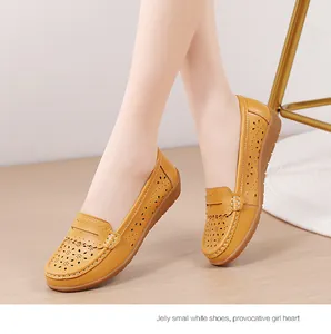 Detail von gelben, durchbrochenen Leder-Loafers mit weicher Sohle und Blumenmuster