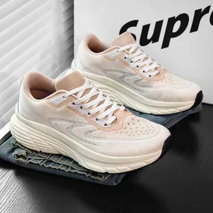 Breathable beige flyknit running shoes with wide fit design displayed on blue denim