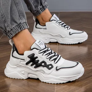 Detailed view of white chunky sneakers with black accents and thick platform soles.
