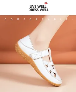 Close-up shot of women's white soft-soled flat sandals with a woven hollow-out design