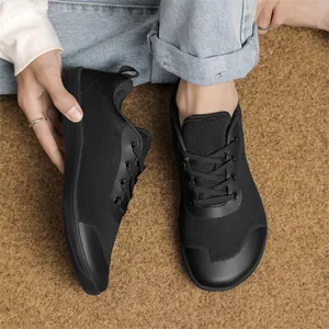 Close-up of black breathable fly-knit wide-toe barefoot shoes for outdoor wear