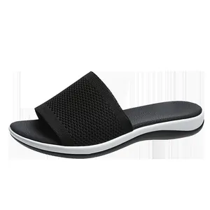 Close-up of black breathable flyknit slide sandal for women on a pure white background