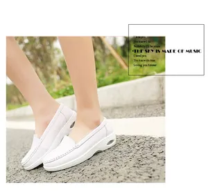 Close-up detail of white leather air cushion nurse shoes featuring a wedge platform sole.