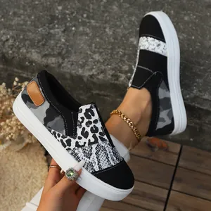 Macro detail of women's leopard and snakeskin print patchwork slip-on canvas shoes