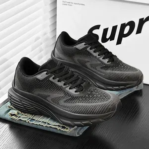 Close-up detail of black breathable fly-knit men's running sneakers on denim fabric