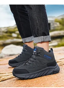 Close-up of durable high-top hiking boots on rocky terrain for outdoor camping