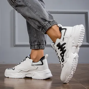 Side detail view of white chunky dad shoes for men with thick soles and black accents.