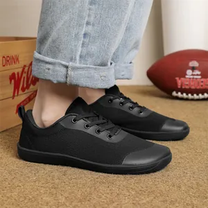 Close-up view of black wide toe box barefoot shoes with breathable mesh upper.