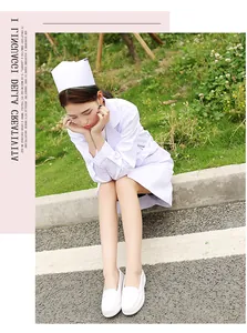 Comfortable white leather wedge nurse shoes worn by a model in a natural outdoor setting