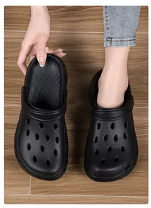 Close-up detail of black EVA clogs featuring breathable holes and non-slip thick soles