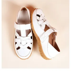Detailed top view of white summer hollow out flat sandals with soft and durable rubber soles