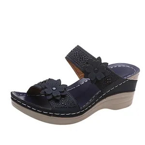 Elegant navy blue wedge sandal featuring decorative flowers and sparkling rhinestones