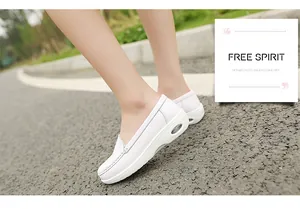 Side view of white leather nurse shoes with a visible air cushion wedge heel.