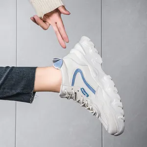 Stylish white microfiber chunky dad sneakers for women with blue accents and thick soles.