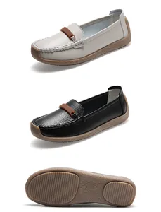 Detailed view of comfortable women's leather loafers in white and black with soft soles