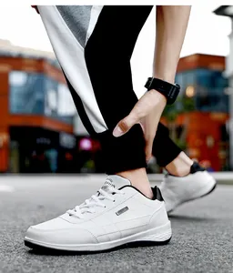 Close-up of white leather men's sneakers with black accents in street lifestyle setting