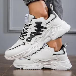 Close-up of white men's chunky sneakers with black accents and platform sole