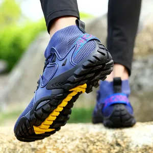 Detail view of the durable anti-slip rubber sole on blue mid-cut outdoor hiking shoes.