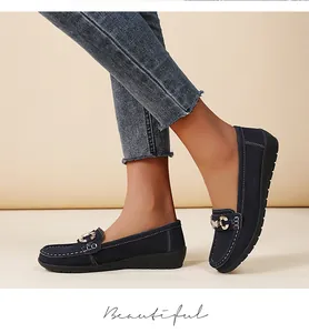 Classic navy blue suede loafers for women featuring a gold buckle detail and casual flat sole