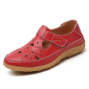 Stylish red hollow-out flat leather sandals for women featuring floral pattern gum sole
