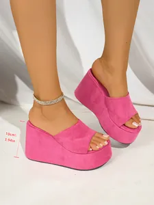 Detailed view of pink suede platform wedge sandals featuring a 10cm or 3.94 inch heel height