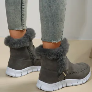 Gros plan de bottines d'hiver grises avec bordure en fausse fourrure et semelle blanche.