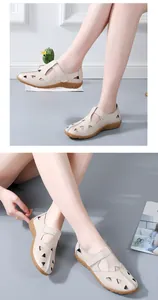 Detailed view of women's beige hollow-out leather sandals on a model for casual wear