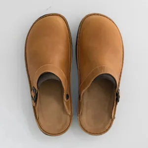 Top view of men's casual tan leather mules with side buckle and flat sole for comfort