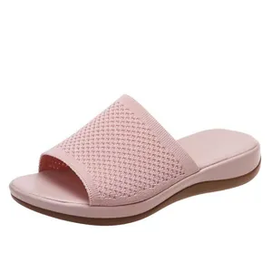 Detailed view of the breathable pink knitted upper on women's casual slide sandals