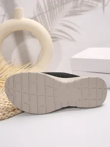 Close-up detail showing the durable anti-slip tread pattern on a platform slipper sole