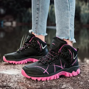 Black and pink high-top hiking boots for outdoor trekking and climbing on rocks.