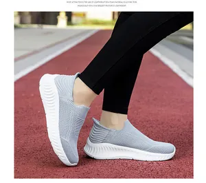 Lightweight grey knit slip-on walking shoes for men and women on red track