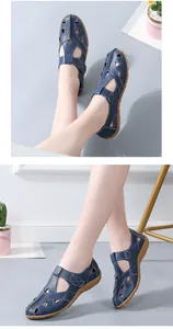 Close-up of blue hollow leather sandals with stitching detail and rubber sole