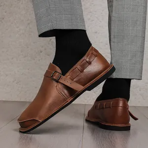 Detailed side view of brown wide-toe leather men's shoe with stylish buckle strap