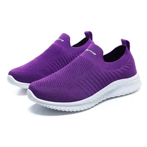 Side view detail of purple slip-on breathable walking shoes with white soles