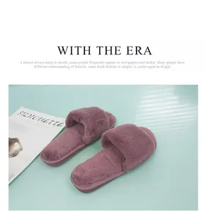 Cozy purple faux fur slippers displayed on a stylish light blue surface with magazine