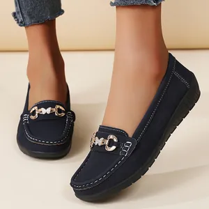 Stylish dark blue women's flat loafers with decorative butterfly buckle and contrast stitching