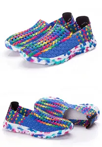 Detail of colorful elastic woven breathable loafers with rainbow patterns and splattered soles.