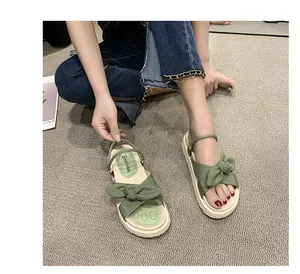 Trendy green platform sandals with bow strap detail and comfortable thick sole for summer