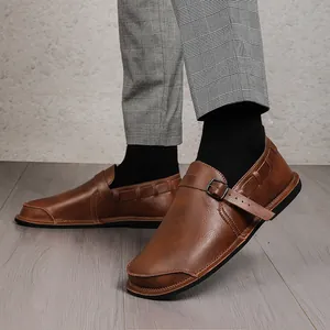 Vintage brown leather barefoot shoes for men with a wide toe box and buckle strap