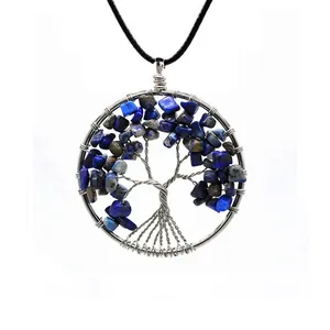 Detail of blue natural stone Tree of Life wire wrapped necklace pendant on white background