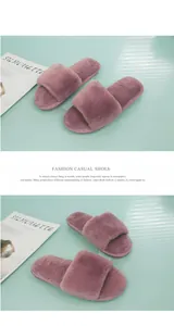 Top down view of fuzzy mauve plush home slippers presented on a light blue surface