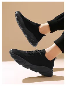 Macro view of black lightweight breathable fly-knit sneakers featuring soft non-slip sole