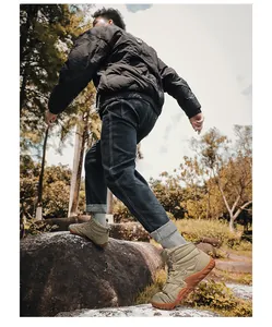 Men's khaki winter hiking boots with plush lining shown in an outdoor park setting.