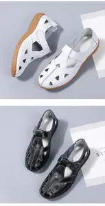 Detail view of genuine leather hollowed-out casual flat shoes in white and black