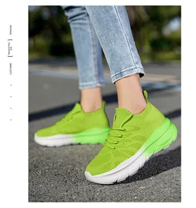 Vibrant lime green fly-knit sock sneakers featuring comfortable thick white soles.