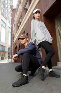 Detailed outdoor view of couple wearing black non-slip five-finger winter snow boots