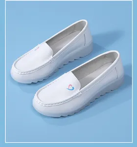 Detailed view of comfortable white nurse shoes with blue and pink heart embroidery